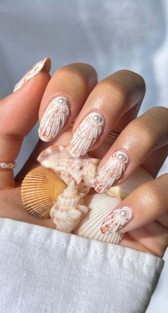 ocean blue shell nail art with pearl accents