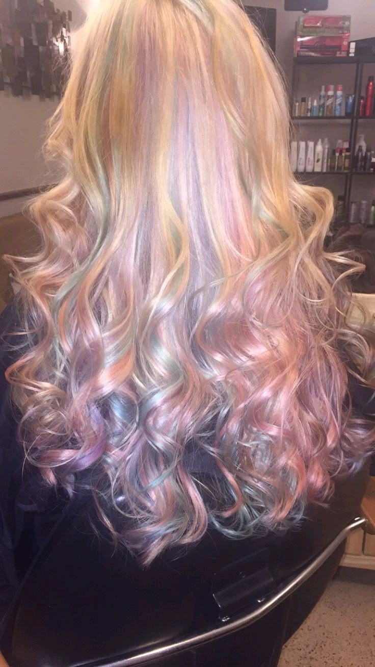 Blonde hair with earth-inspired pastel pink, lilac and sage streaks styled in voluminous curls