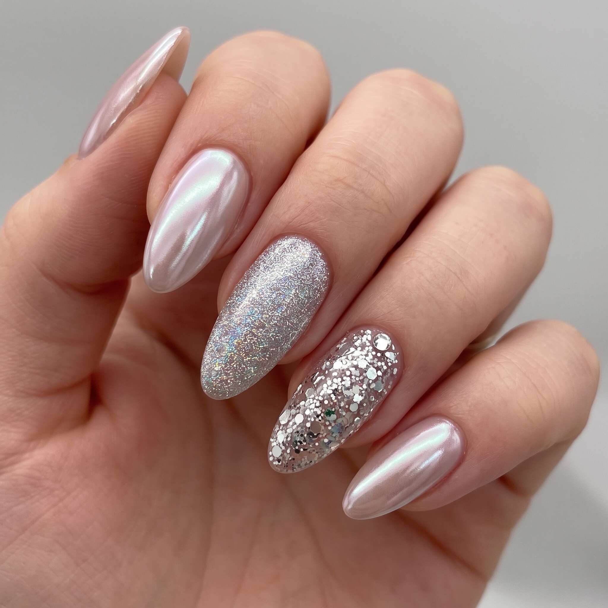 Nude nails with glitter accent finger for graduation