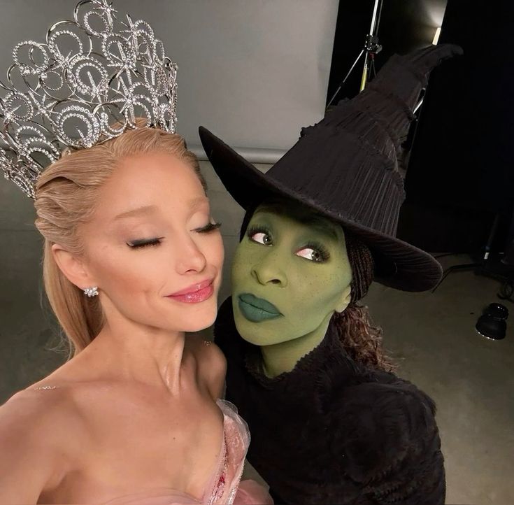 Glinda and Elphaba duo Halloween costume with a pink crown and green face paint