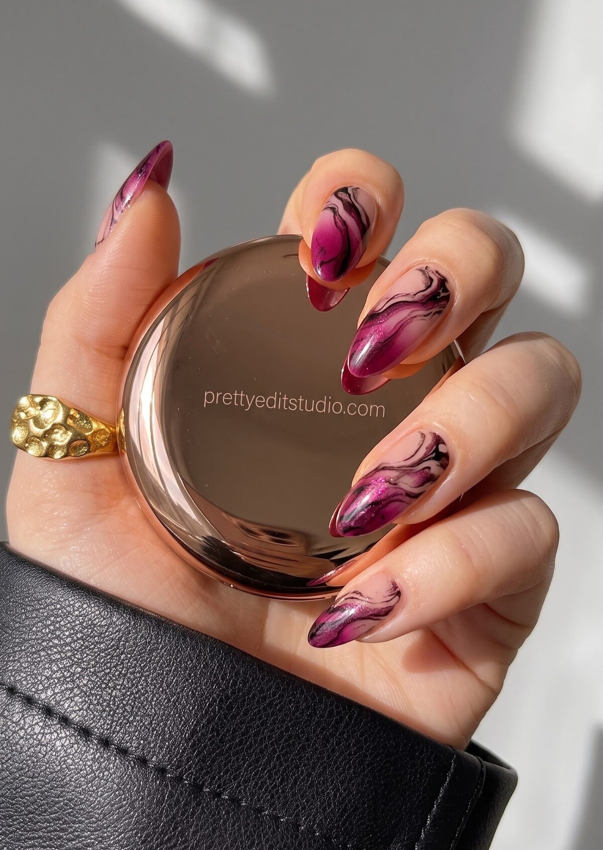 Magenta and burgundy marble swirl nail art with a glossy finish