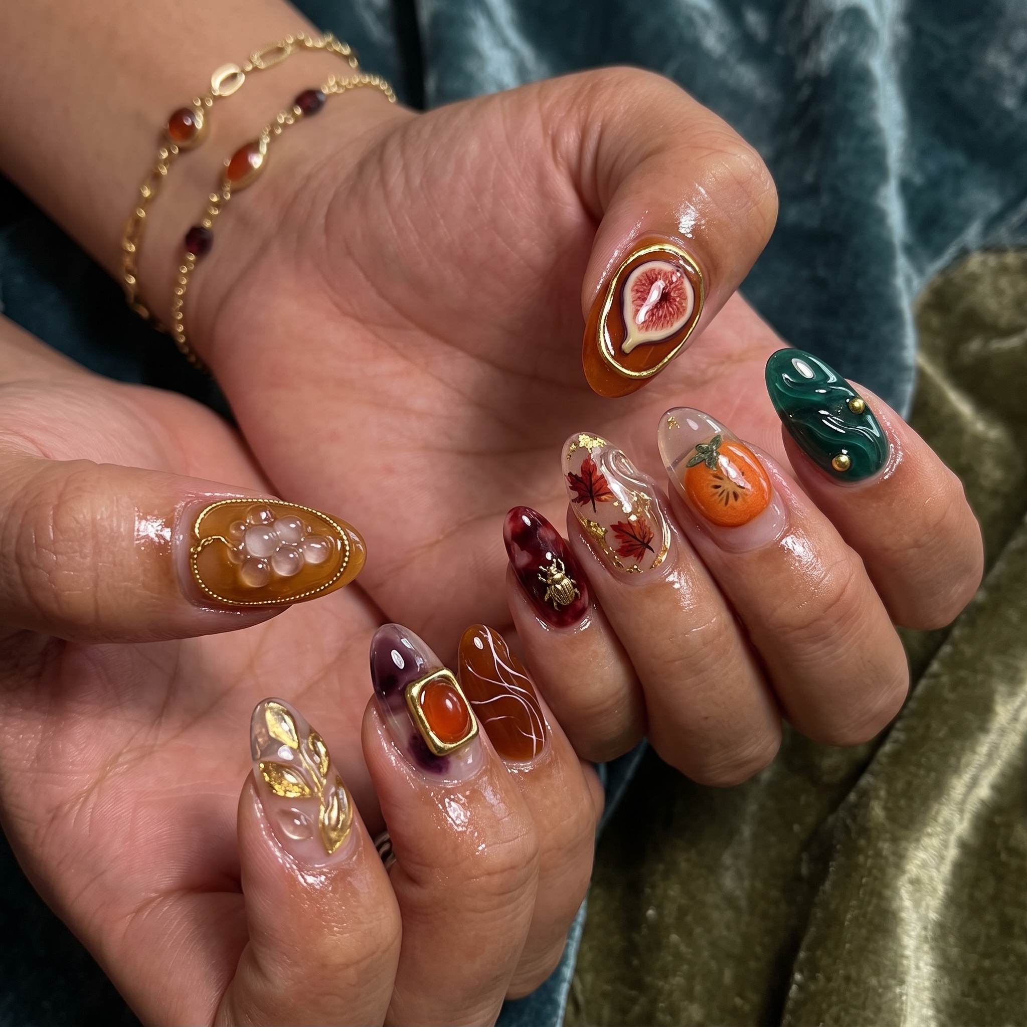 Autumn harvest cat eye nails with fig, grape, and gold charm details