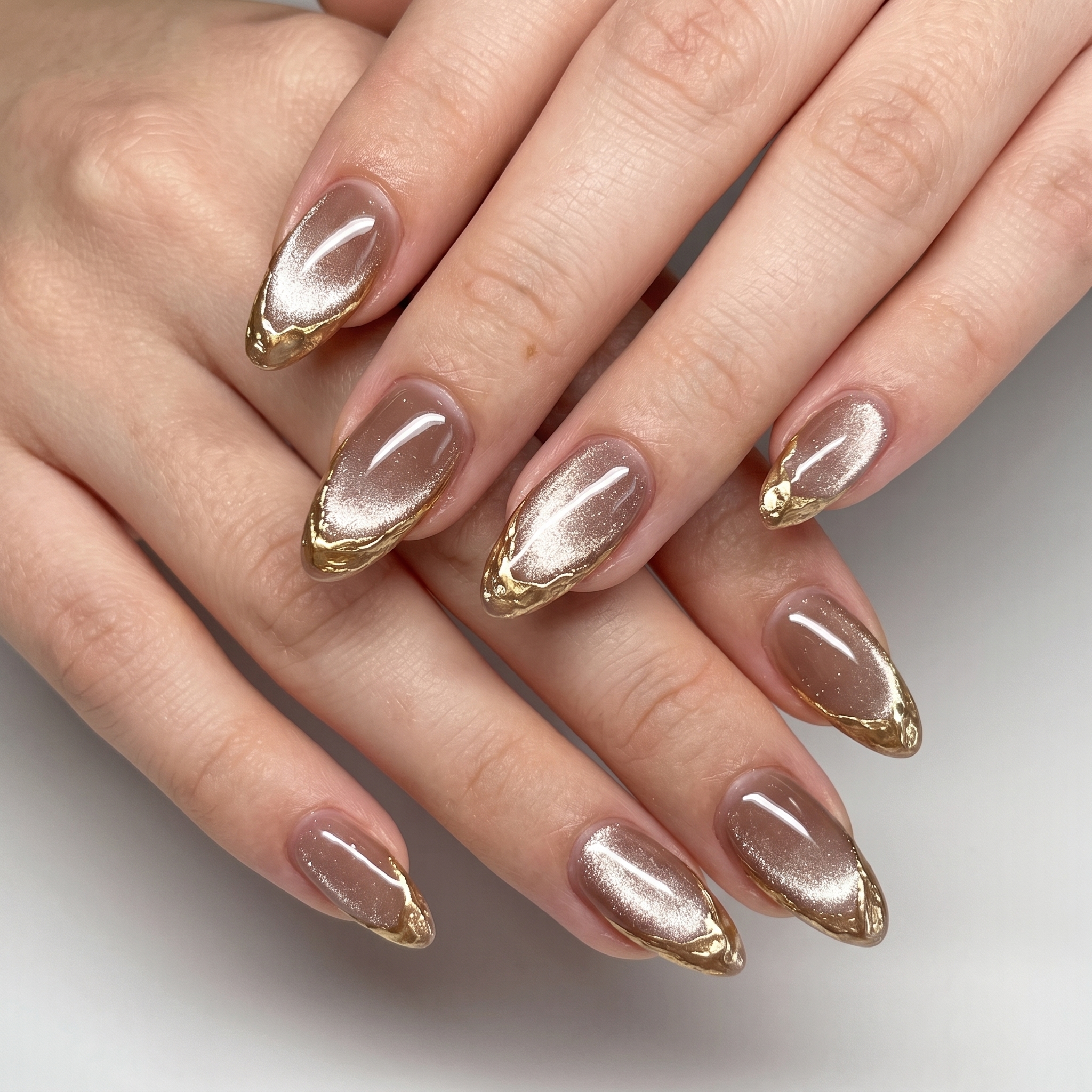 Champagne nude cat eye nails with gold cat eye french tips