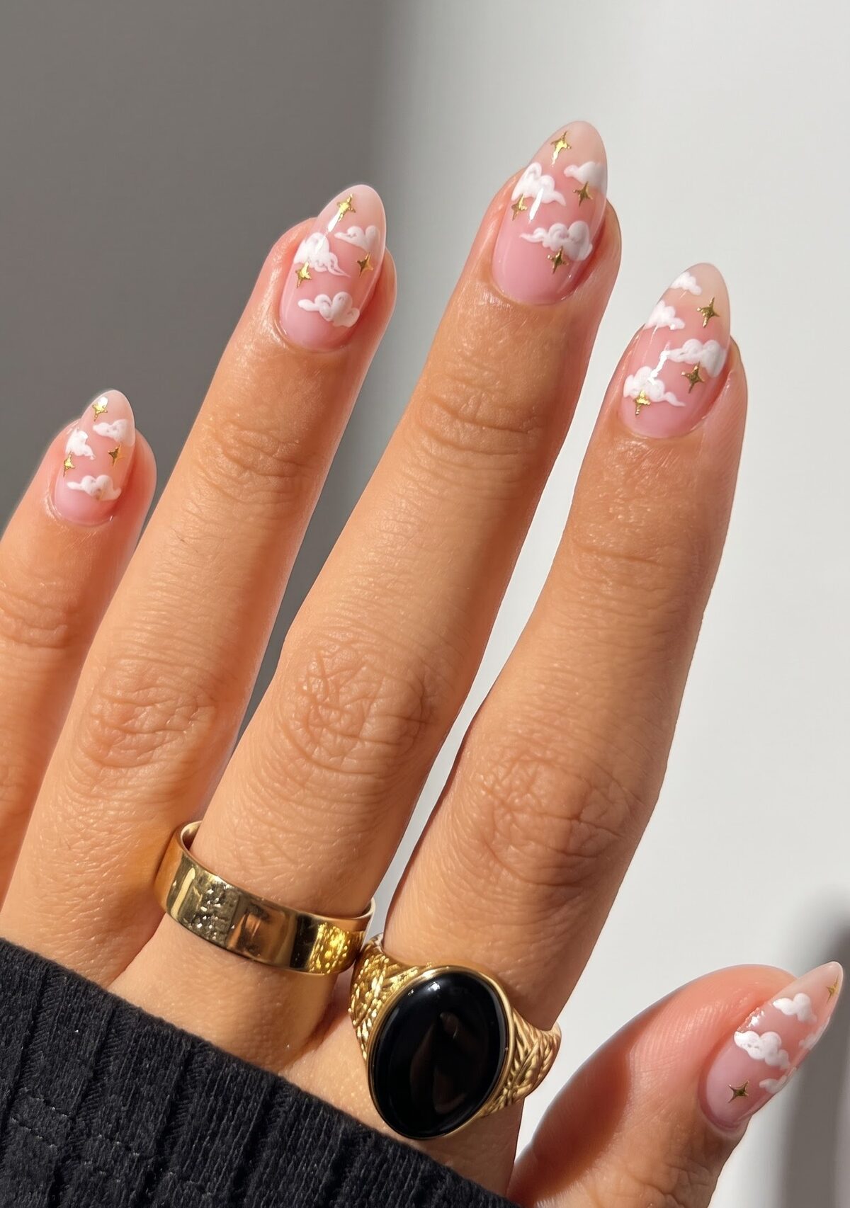 Nude nails with white fluffy cloud art and small gold stars
