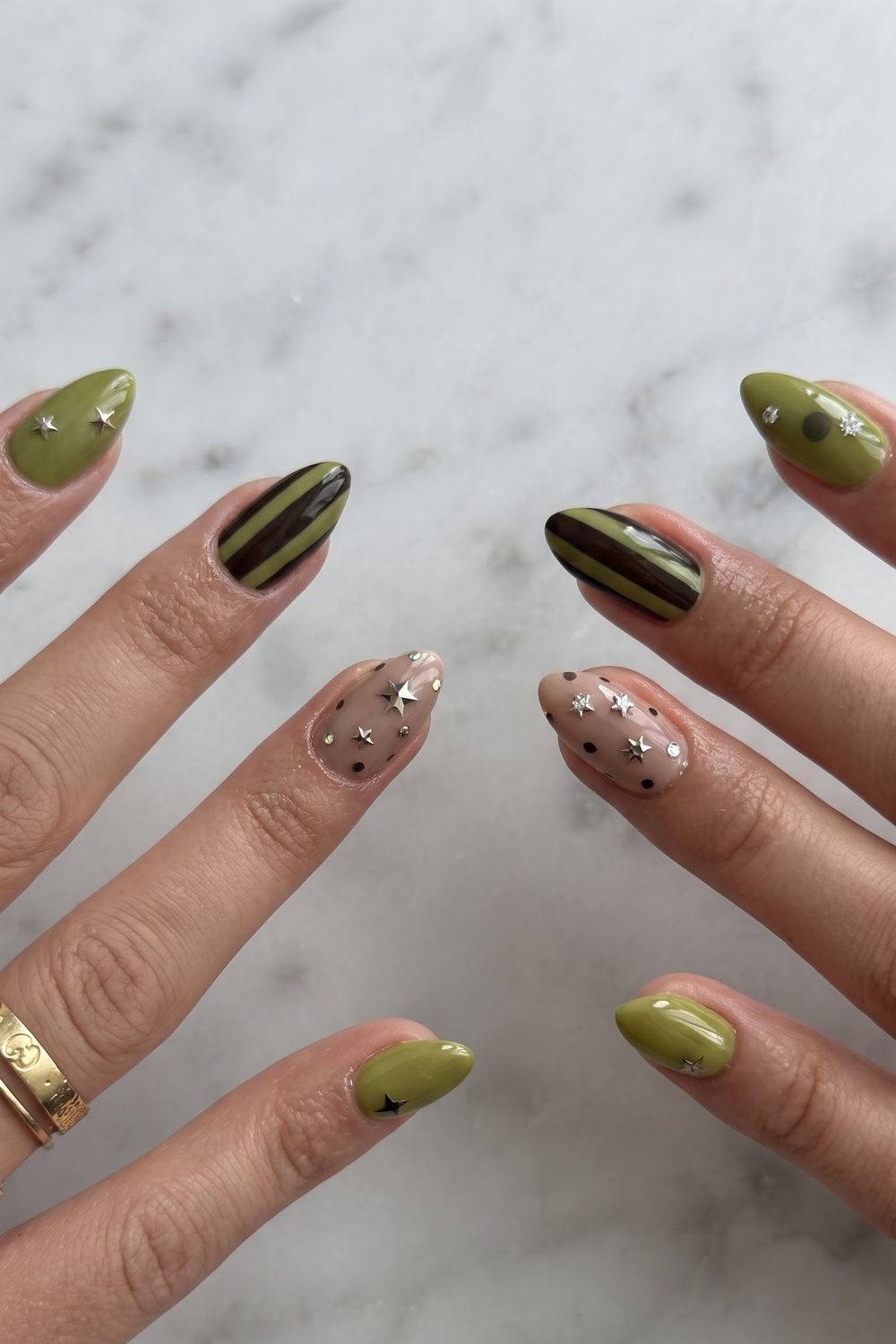 Abalone gold marble fall nails styled with gold rings