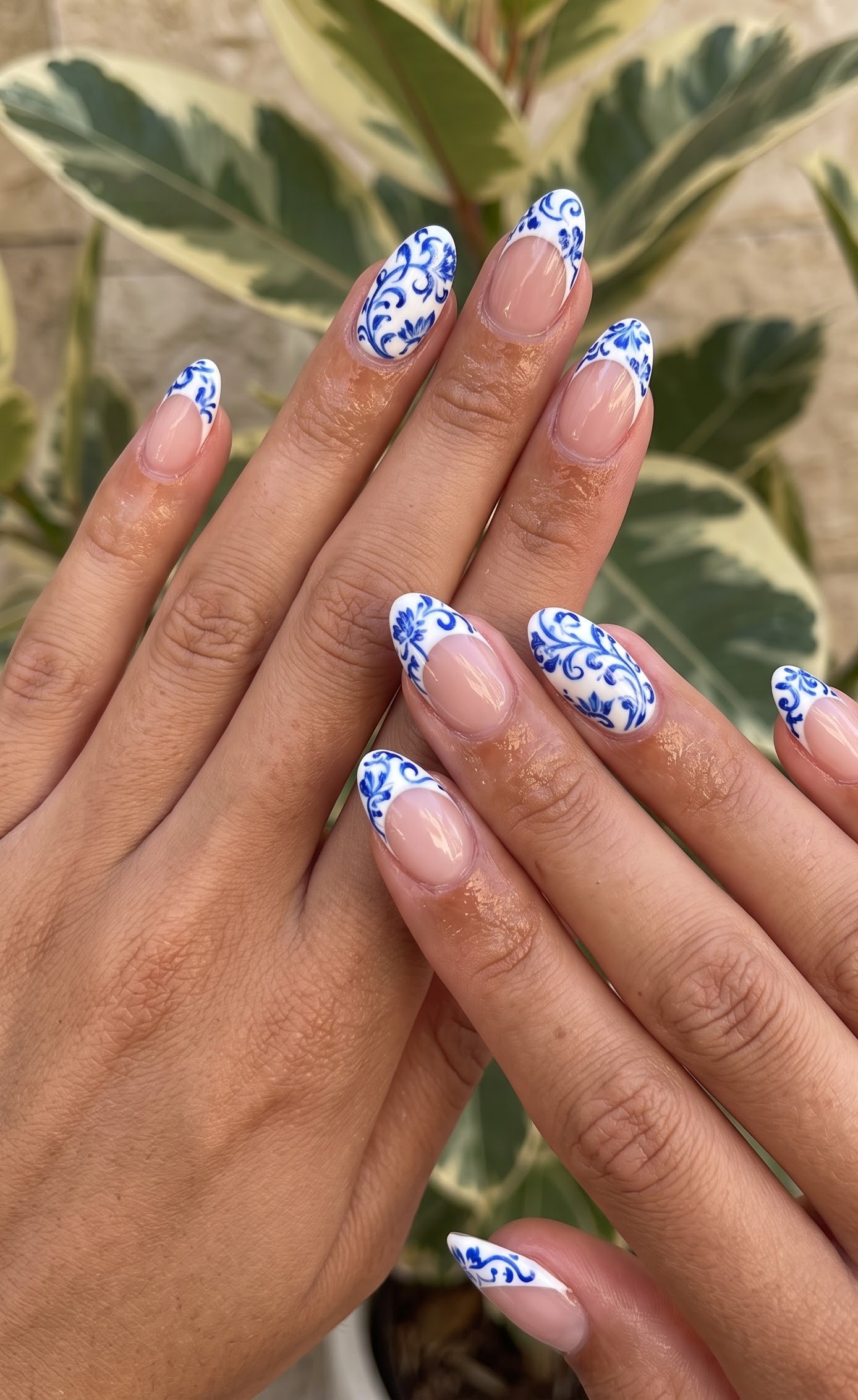 Almond nails with cobalt blue porcelain-style floral french tips