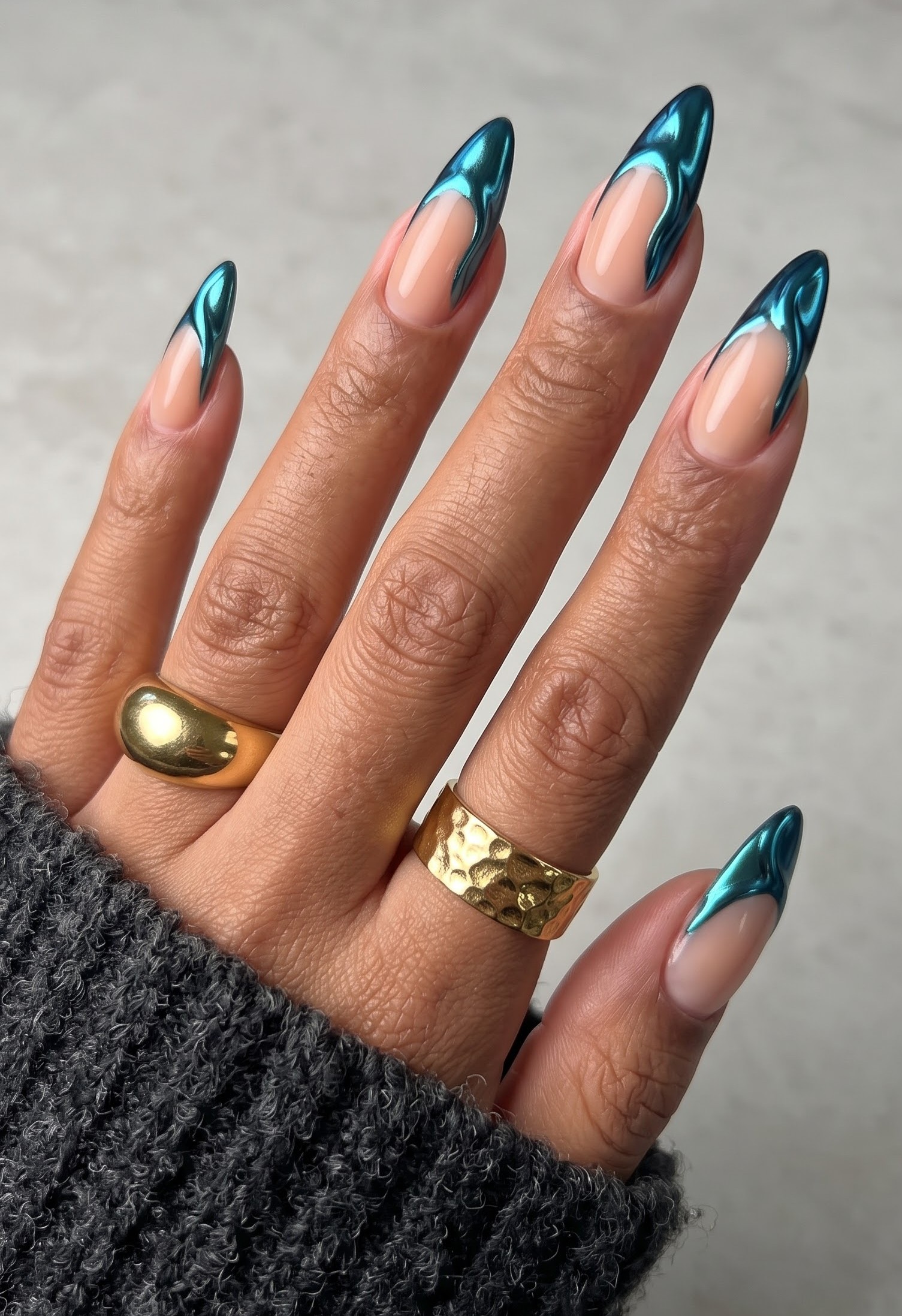 Nude stiletto nails with high shine teal chrome french tips