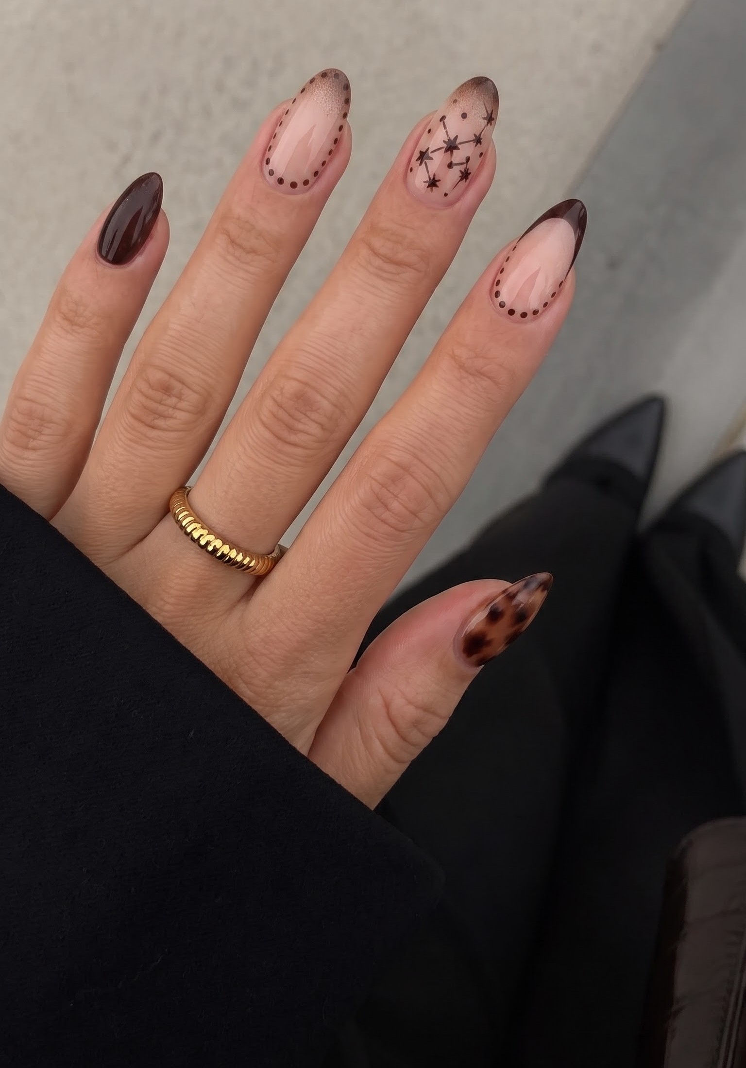 Brown ombre french tips with dotted borders and a hand-painted constellation nail