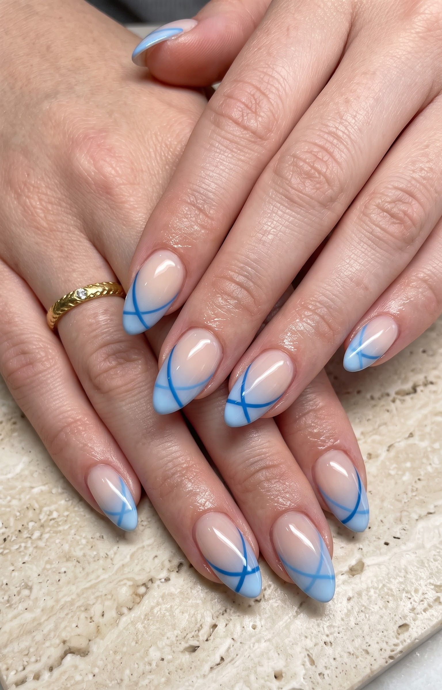 Nude almond nails with pale blue crisscross line french tips