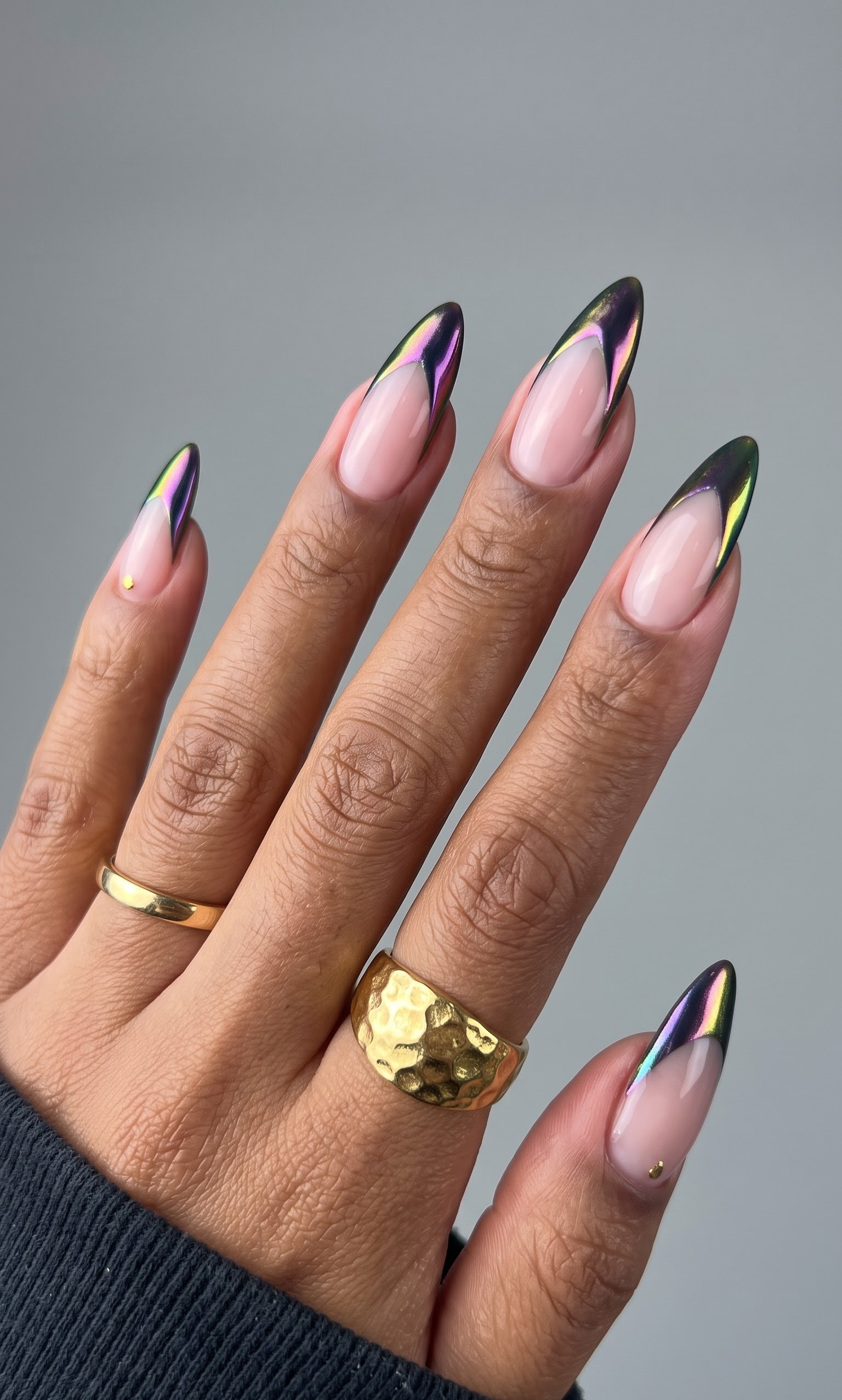 Nude almond nails with holographic dark green and purple shifting french tips