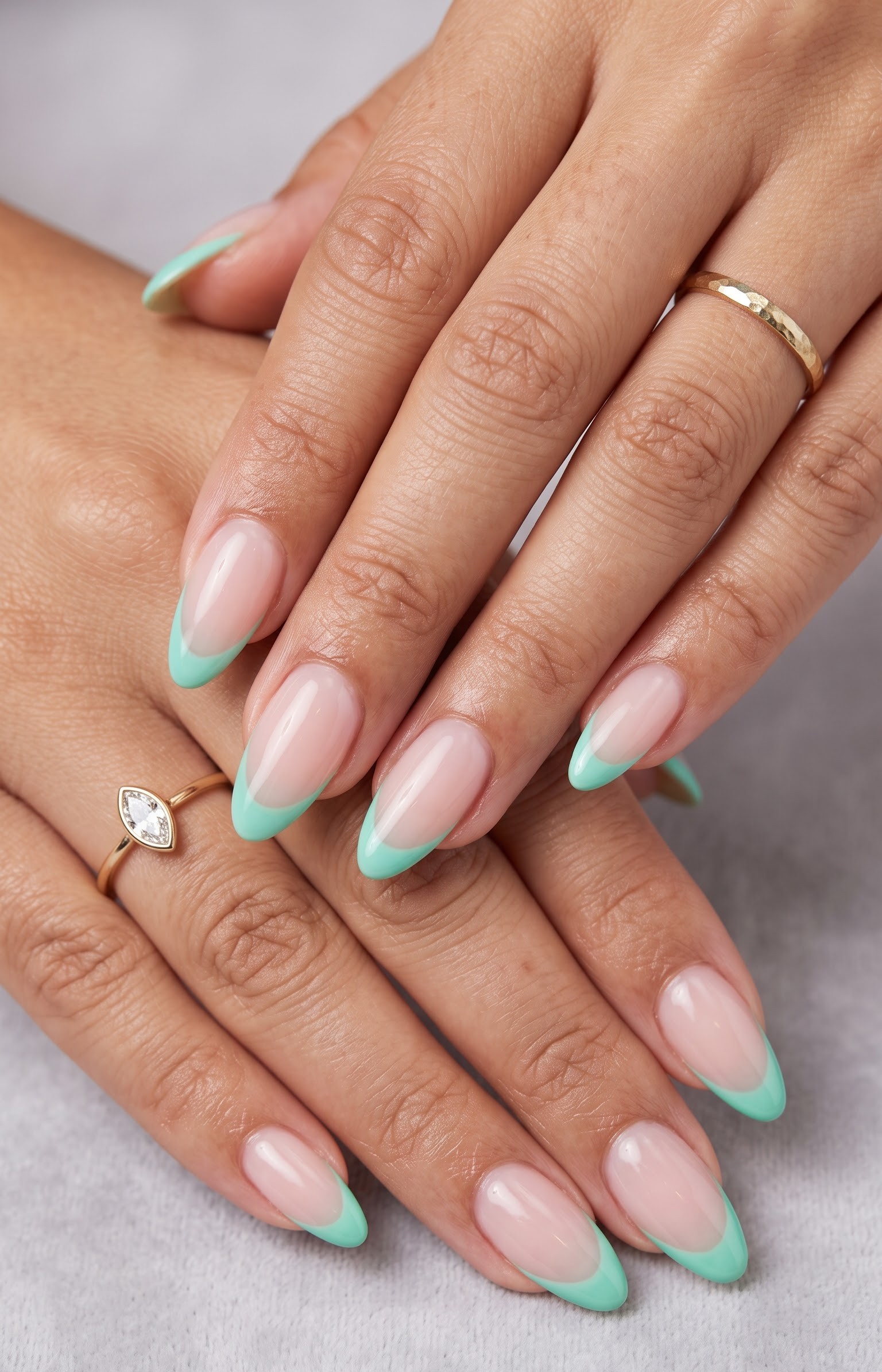 Nude almond nails with a classic soft mint green french tip