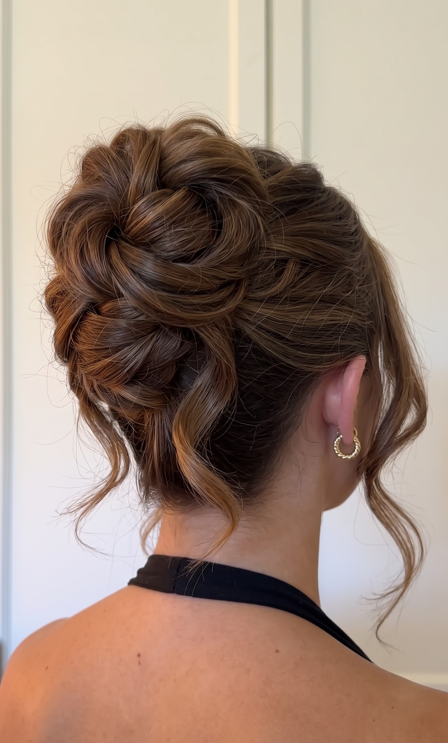 hairstyles upstyles - textured high bun with gold hoop earring