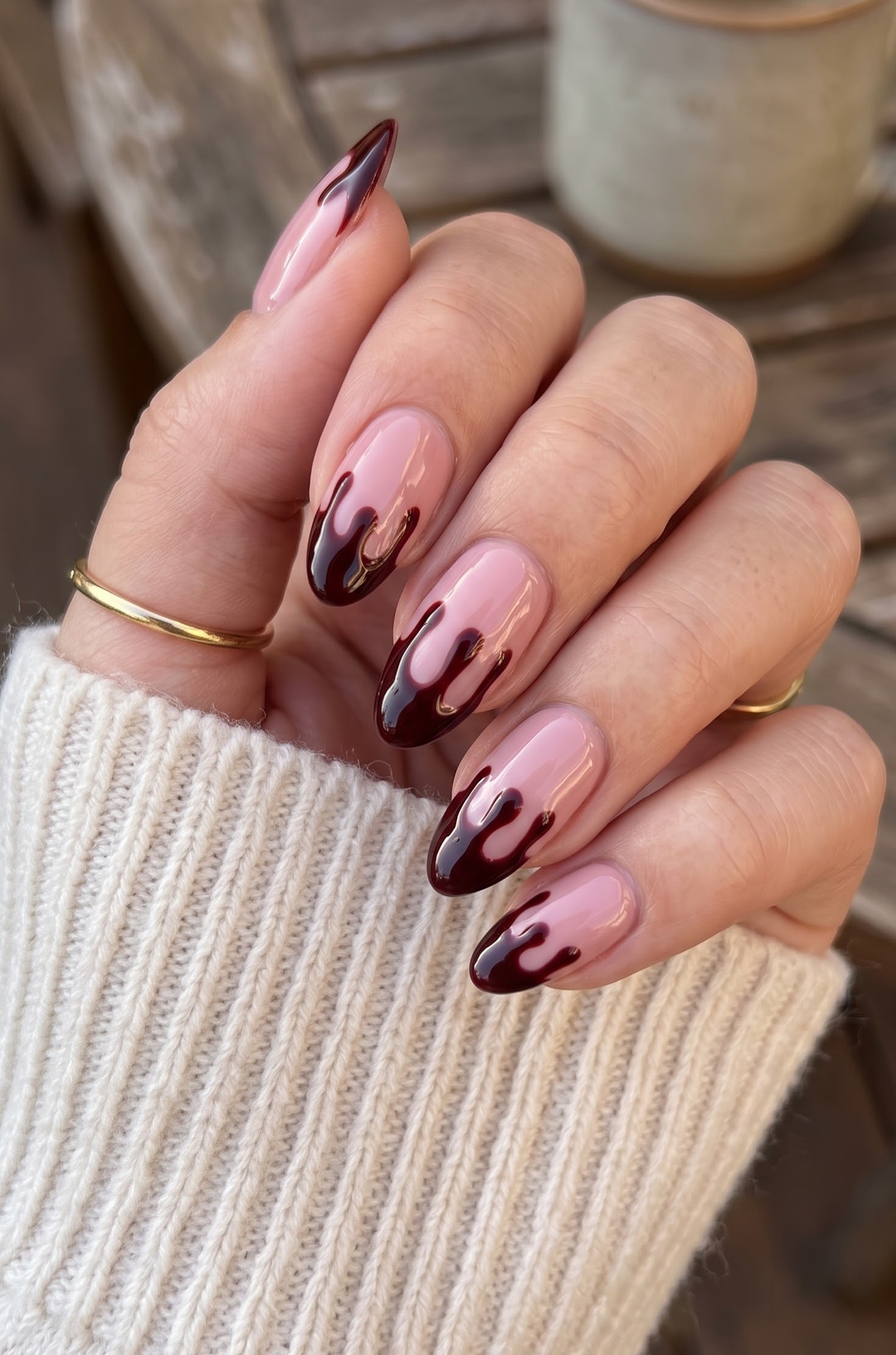 Soft pink Halloween nails with a dark red blood drip french tip