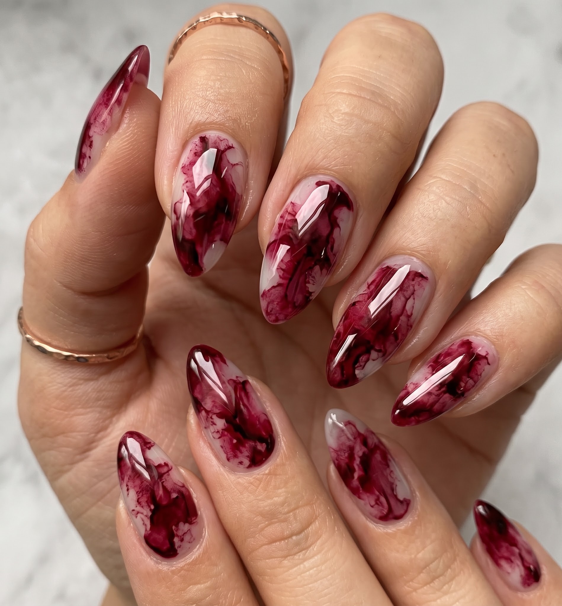 Sheer burgundy marble Halloween nails resembling a blood smoke effect
