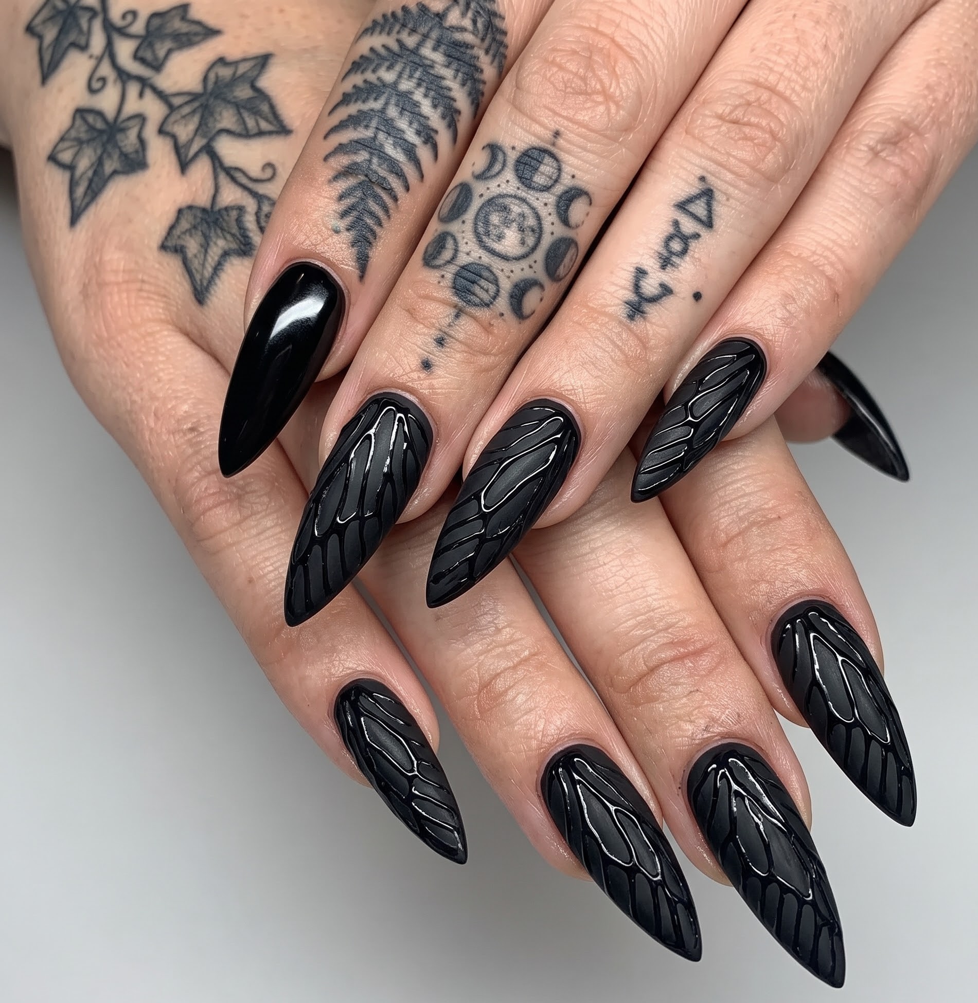 Matte and glossy black Halloween nails with gothic damask lace patterns