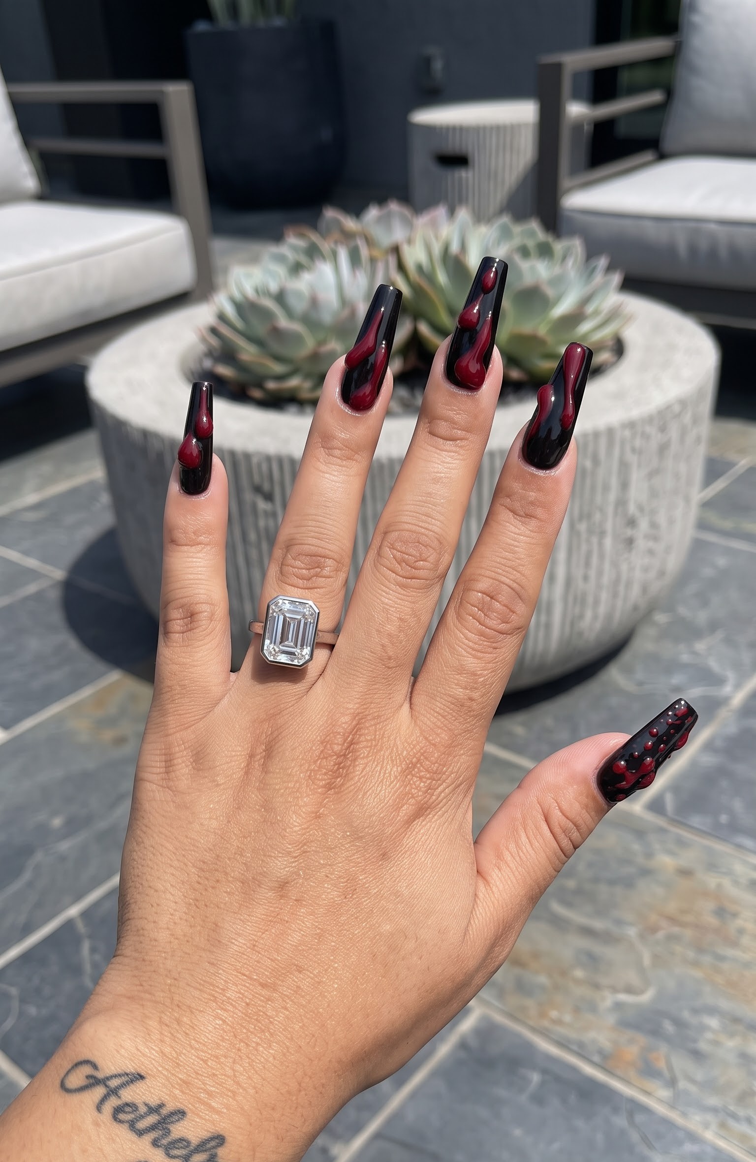 Black coffin Halloween nails with a dark red melting blood drip design