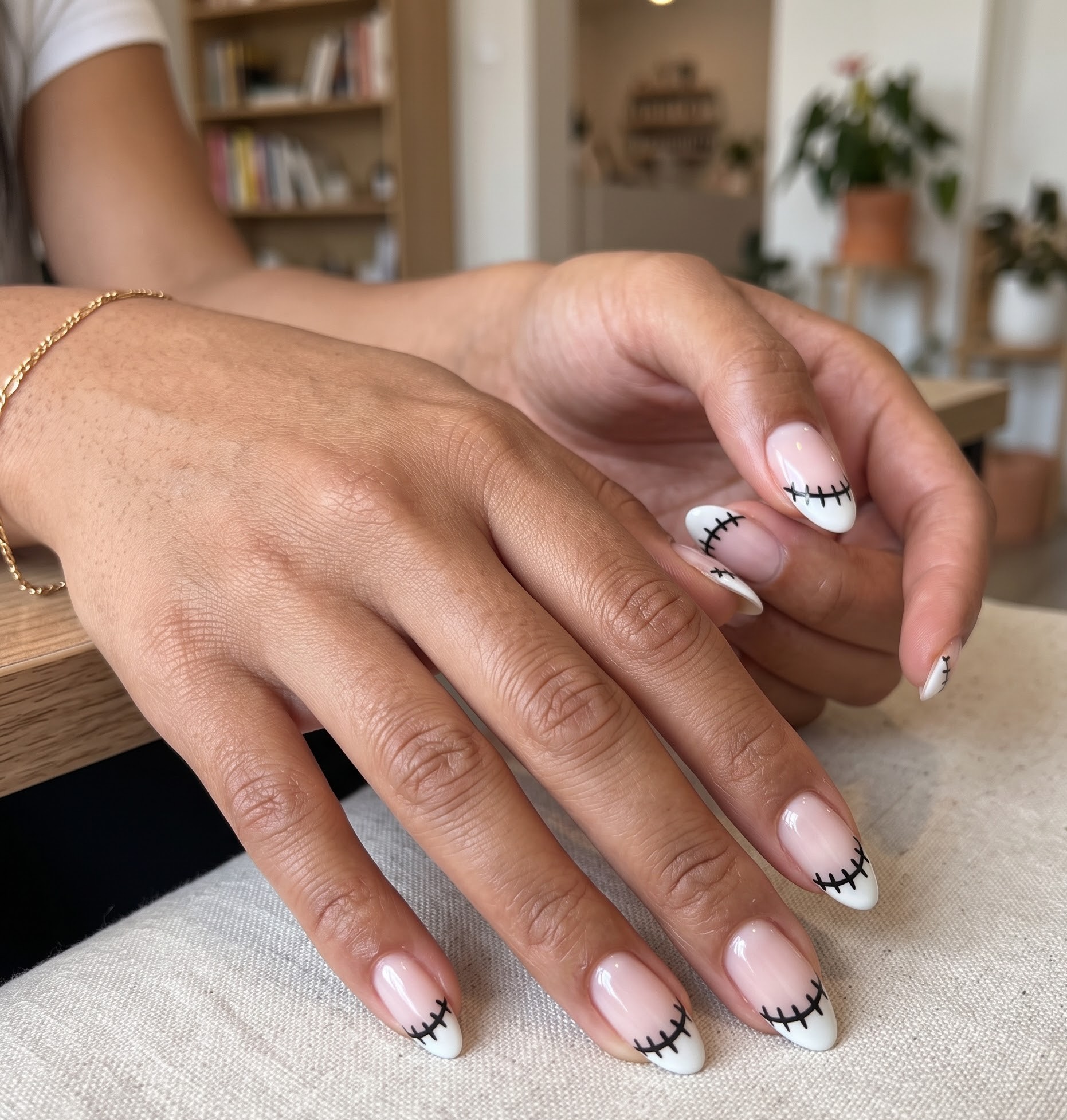 White Halloween french tip nails with black stitch details