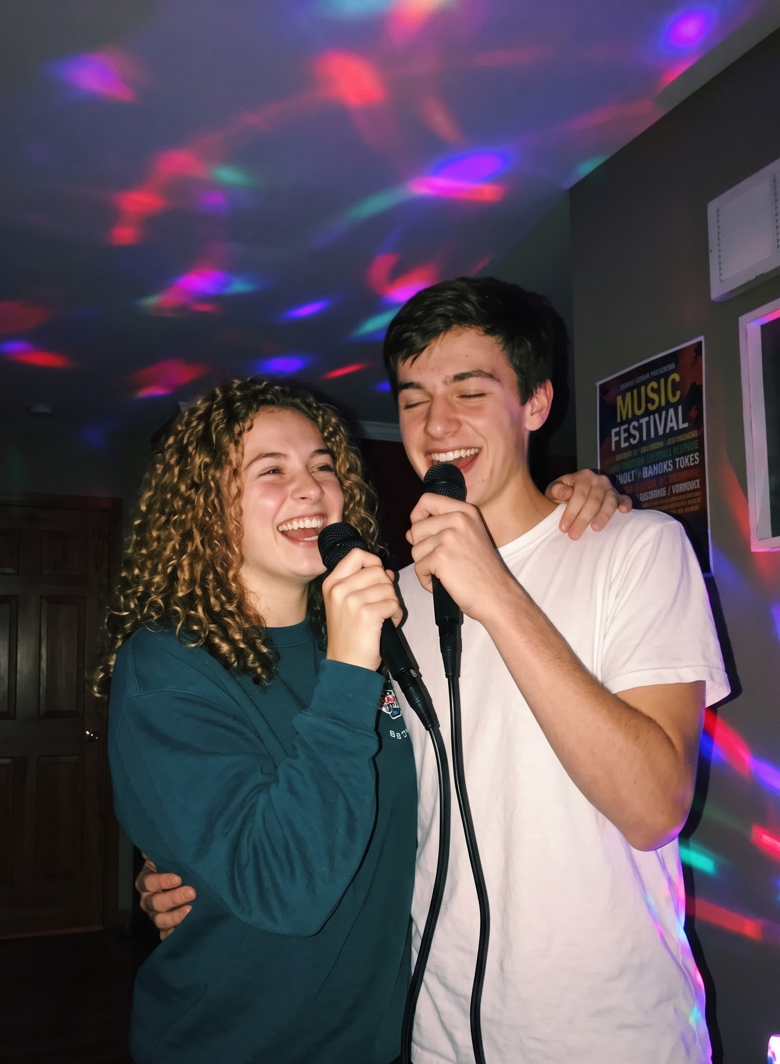 Couple singing together into microphones with colorful party lights in the background