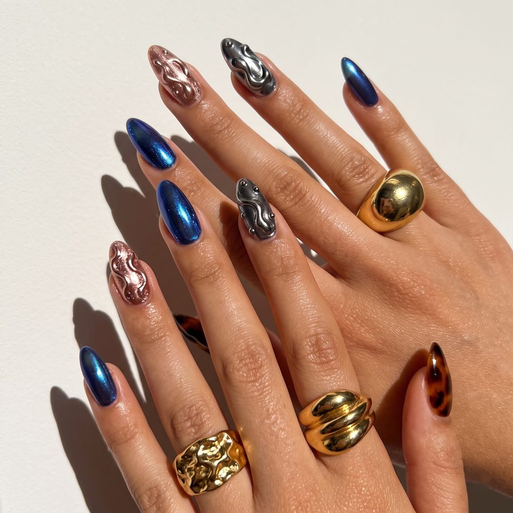 Blue chrome almond nails with 3D liquid metal rose gold and silver swirl accent nails