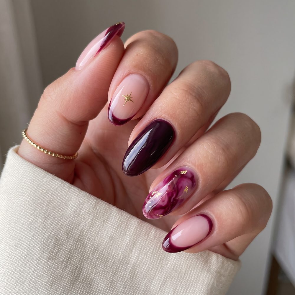 Burgundy marble almond nails with gold star charm and burgundy micro French tips