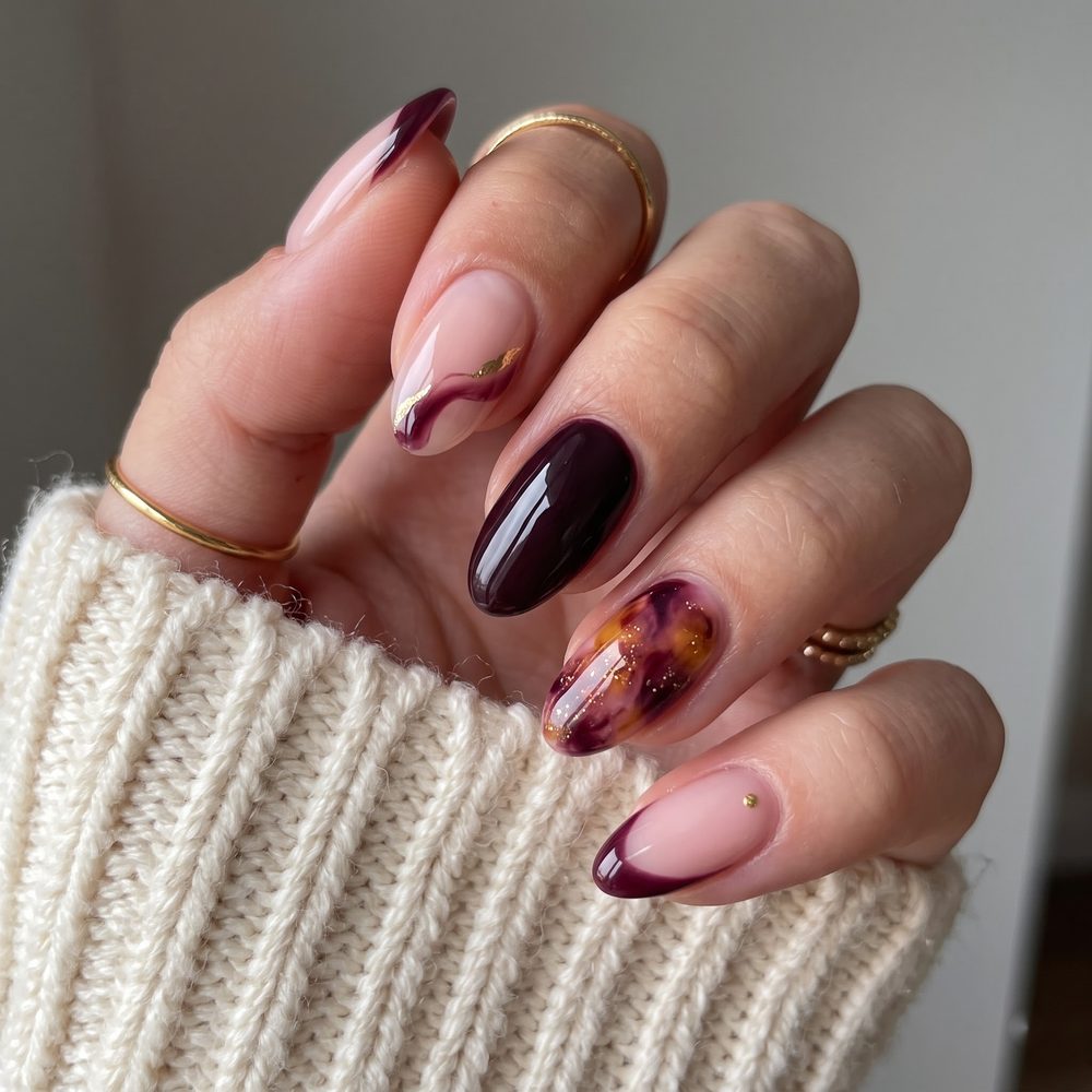 Burgundy marble and tortoiseshell almond nails with gold foil swirl