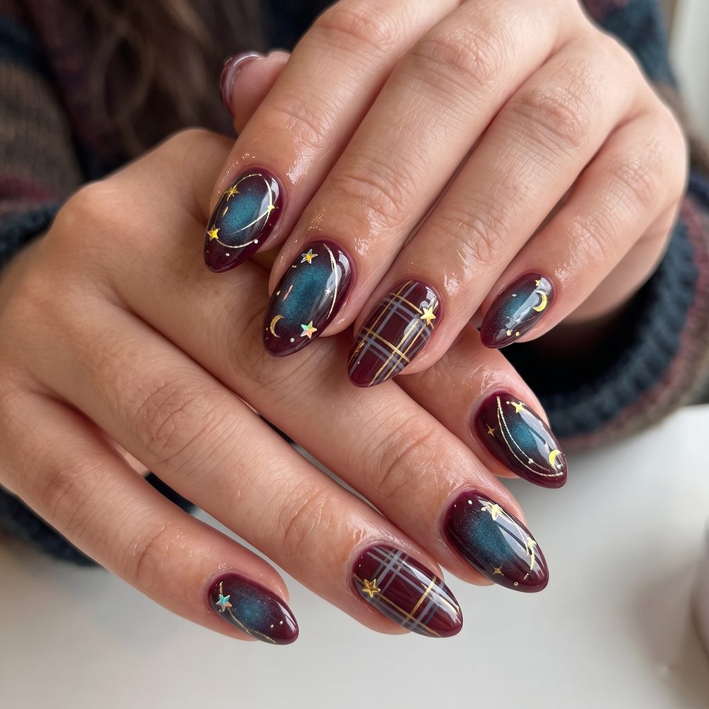 Burgundy almond nails with teal galaxy aura, gold plaid lines and star and moon charms