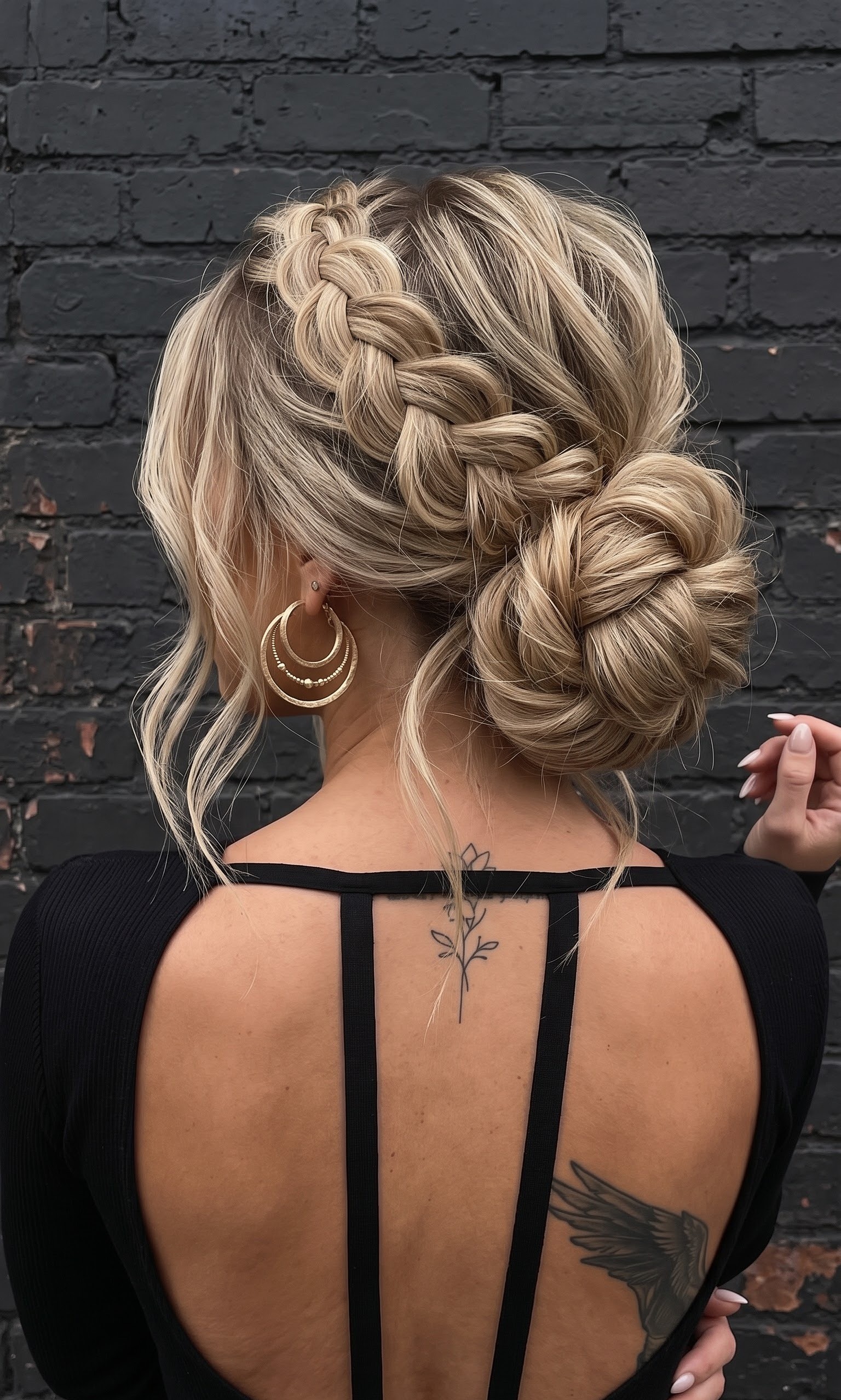 sleek updo hairstyles - polished woven chignon with diamond earrings