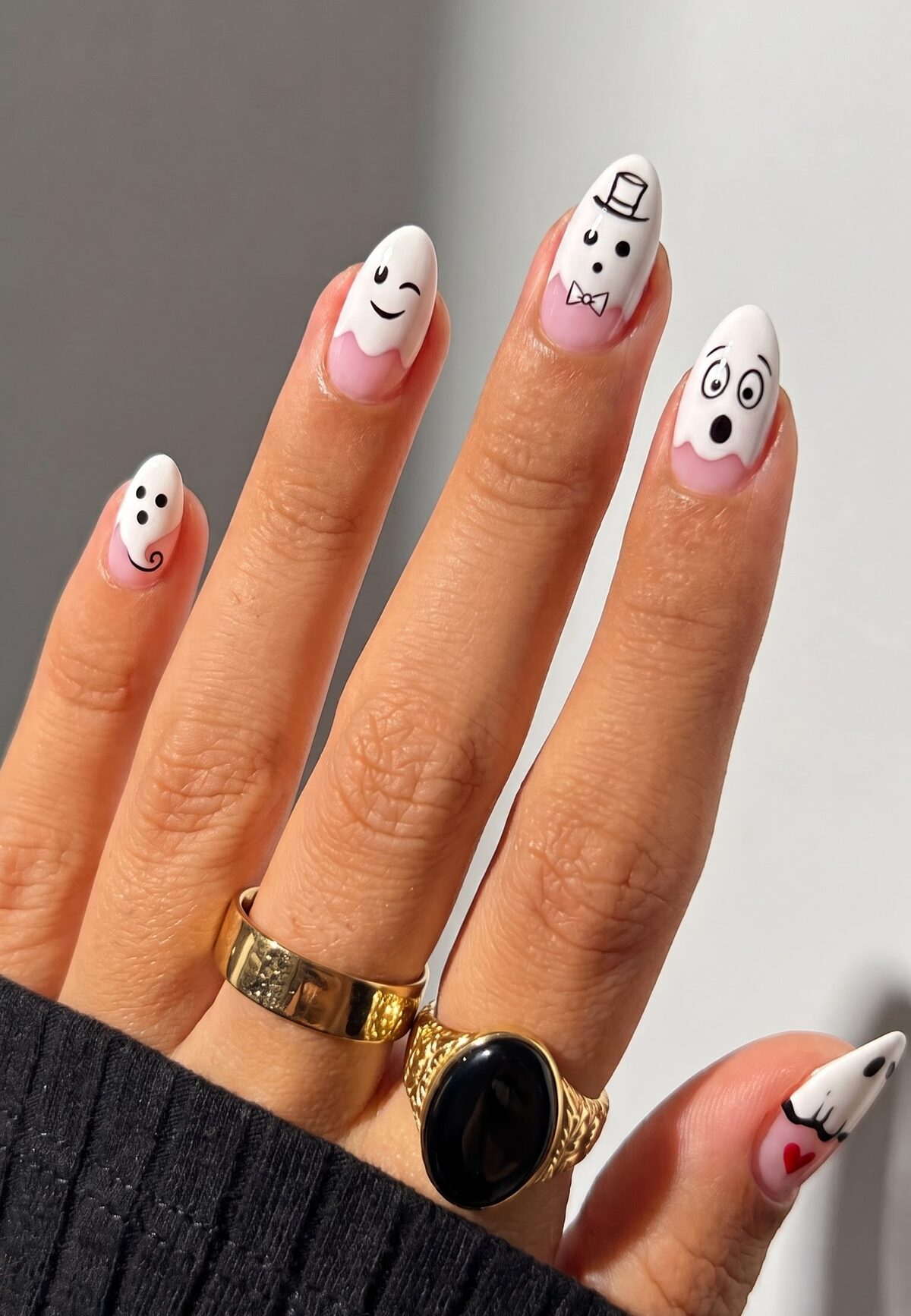 White ghost face nails with different expressions, a top hat, bow tie and a small red heart