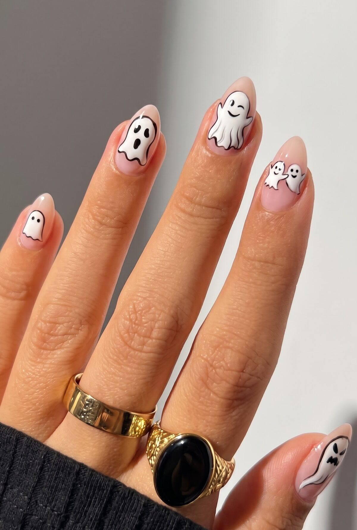 Nude nails with hand painted winking and smiling ghost characters and gold rings
